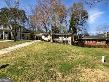 Charming ranch home with a spacious lawn and mature trees at 1288 Fairhill Ne Ln, Brookhaven, GA 30319