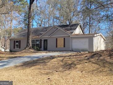 Traditional single-story home with a driveway and attached one-car garage at 110 Peridot Pl, South Fulton, GA 30349