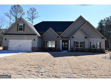 Gray two-story house with a three-car garage and large yard at 329 Rays Ct # 12, Grayson, GA 30017