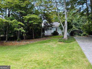 Charming single-story home with a lovely front yard and a covered carport at 2606 Ramblewood Ct, Acworth, GA 30102