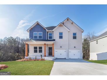 Two-story home boasting a brick facade, a two-car garage, and a well-manicured lawn at 271 Orwell Dr # 49, Social Circle, GA 30025