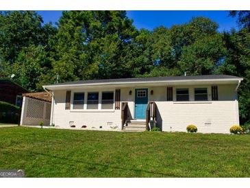 Charming single-story home with a well-manicured lawn and inviting blue front door at 749 Casplan Sw St, Atlanta, GA 30310