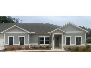 Charming single-story home featuring gray siding, a brick foundation, and a covered front entrance, offering modern comfort at 3867 Shelleydale Dr # 84, Powder Springs, GA 30127