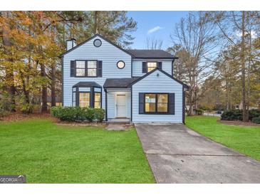 Newly painted 2-story house with a well-manicured lawn and driveway at 1008 King Rd, Riverdale, GA 30296