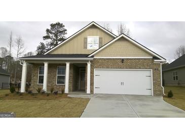 Brick house with a two-car garage and a covered front porch at 576 Parnassus Road, Locust Grove, GA 30248