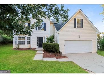 Charming two-story home with a well-manicured lawn and attached two car garage at 137 Legend Creek Dr, Canton, GA 30114