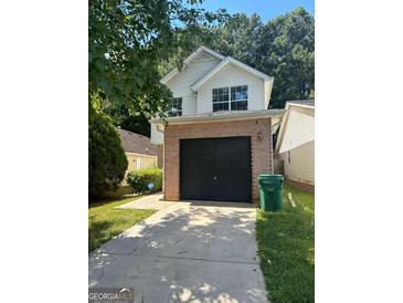 Charming two-story home features a brick-front garage and a well-maintained lawn at 3651 Sapphire Ct, Decatur, GA 30034