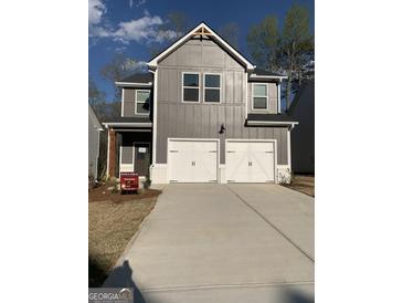 Charming two-story home featuring a two-car garage, gray siding, and a well-manicured lawn at 172 Weldon Rd # 19, Mcdonough, GA 30253