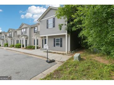 Charming two-story townhome with gray siding and black shutters near a basketball hoop at 4001 Avalon Sw Rd, Atlanta, GA 30331
