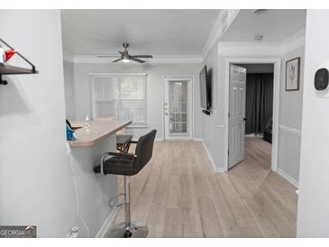 Bright, open living area with light wood floors, bar seating, and access to the outdoors at 2700 Pine Ne St # 2108, Atlanta, GA 30324