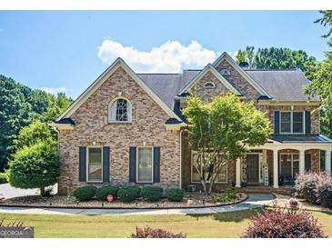 Brick two-story house with a large front yard and porch at 185 Fieldstone Way, Fayetteville, GA 30215