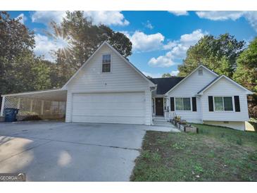 White house with attached garage and landscaped yard at 2785 Amberly Hills Trl, Dacula, GA 30019