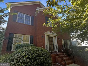 Charming brick home featuring black shutters, manicured landscaping and a welcoming front entrance at 200 Eagle Glen Ct, Woodstock, GA 30189