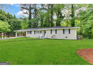 Charming single-story home features a large front lawn and a welcoming entryway with white stairs at 3086 Meadow Lark Ln, East Point, GA 30344