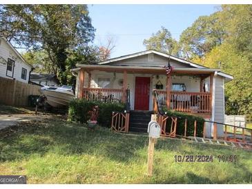 Charming single story home with a front porch and yard at 768 Fourth St, Stone Mountain, GA 30083