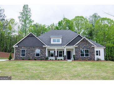 Charming single-Gathering home with stone accents, complemented by well-manicured lawn and lush greenery at 152 Wet Wood Dr # 10, Fairburn, GA 30213
