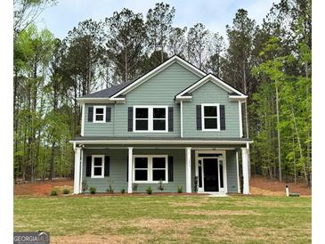 Two-story home featuring gray siding, black shutters, white trim, and a well-manicured lawn at 1555 South Bethany Rd, Locust Grove, GA 30248