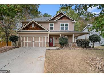 Charming two-story home featuring a front porch, a two-car garage, and tasteful exterior finishes at 1714 Boulder Walk Se Ln, Atlanta, GA 30316