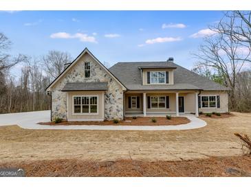 Charming single Gathering home featuring stone accents, neutral color palette, and inviting covered front porch at 426 Ayers Rd, Bowdon, GA 30108