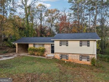 Charming two-story home with a brick facade and a well-maintained front yard at 2825 Battlecrest Dr, Decatur, GA 30034