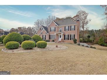 Stately brick home featuring a well-manicured lawn and a classic architectural design at 355 Woodbyne Dr, Fayetteville, GA 30214