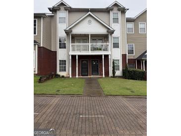 Traditional townhouse showcasing a classic facade, charming balcony, and well-manicured lawn at 251 Ralph David Abernathy Sw Blvd, Atlanta, GA 30312