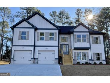 Two-story house with a two-car garage and a landscaped yard at 3278 Greenhill Dr, Villa Rica, GA 30180