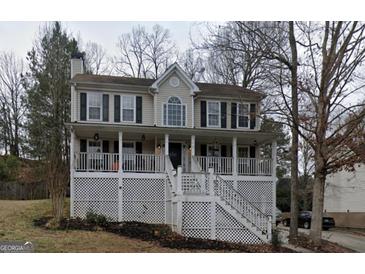 Charming two-story home featuring a spacious front porch and classic architectural details at 3722 Lockerbie Ln, Powder Springs, GA 30127