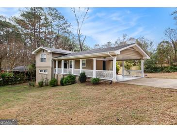 Charming home featuring a covered carport and inviting front porch at 3435 Misty Valley Rd, Decatur, GA 30032
