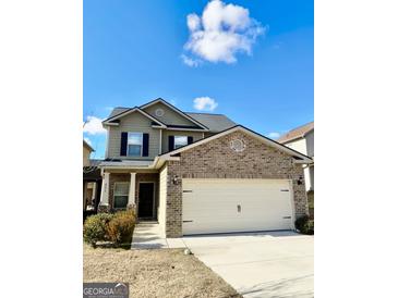 Charming two-story home boasts a brick facade, two-car garage, and well-maintained lawn at 6255 Hickory Lane Cir, Union City, GA 30291