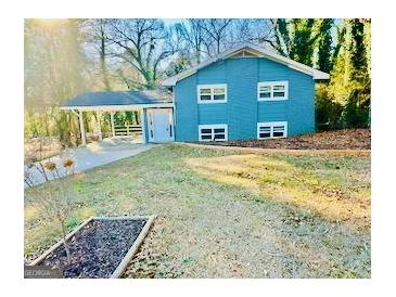 Charming blue two-story home with a carport and well-maintained front lawn at 2803 Norgate Ln, Decatur, GA 30034