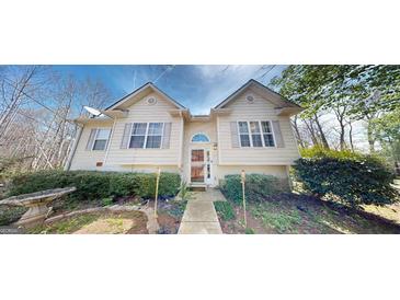 Charming home featuring symmetrical design, neutral siding, and well-maintained landscaping at 15 Huntington Dr, Grantville, GA 30220
