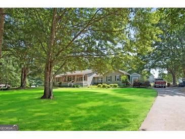 Charming single-story home with a well-manicured front yard and inviting curb appeal at 950 Old Jackson Rd, Locust Grove, GA 30248