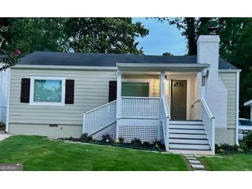 Charming ranch home with a newly renovated exterior, featuring a covered porch and landscaping at 1222 Bronx Nw St, Atlanta, GA 30314