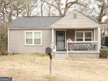 Ranch style home with covered porch and small yard at 561 Commercial Nw Ave, Atlanta, GA 30318