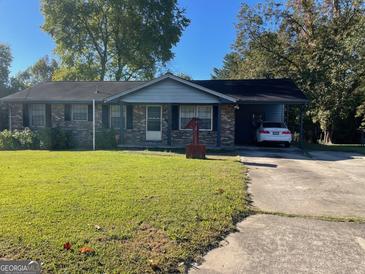 Ranch style home with carport and spacious yard at 266 Ridge Trl, Riverdale, GA 30274