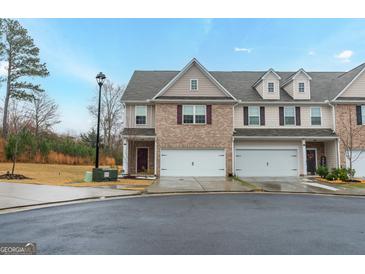 Two-story townhome with brick facade and two-car garage at 3170 Fareed St, Douglasville, GA 30135