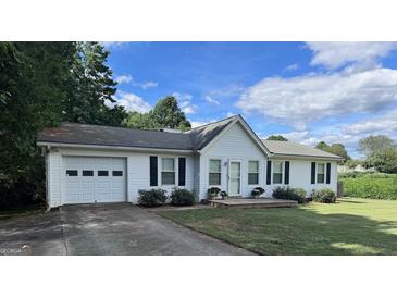 White house with attached garage and landscaped yard at 3772 Saddle Ridge, Snellville, GA 30039