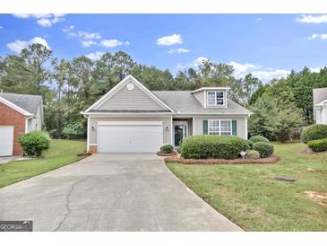 Ranch-style home with two-car garage and landscaped lawn at 701 Brambling Way, Stockbridge, GA 30281