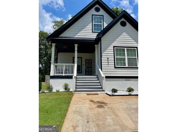 Charming 2-story house with white siding, black accents, and a landscaped yard at 78 Bisbee Se Ave, Atlanta, GA 30315