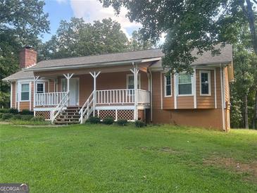 Ranch style home with large front porch and expansive lawn at 216 Rivers Rd, Fayetteville, GA 30214
