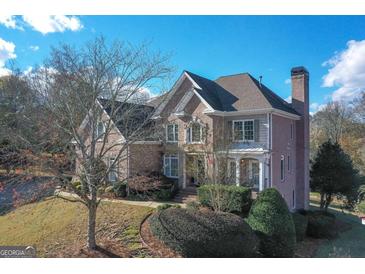 Brick two-story home with landscaped yard and large windows at 3443 Pinemont Dr, Douglasville, GA 30135