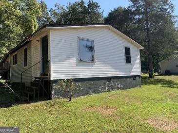 White single-story house with steps and small yard at 200 Eleanor Dr, Covington, GA 30016