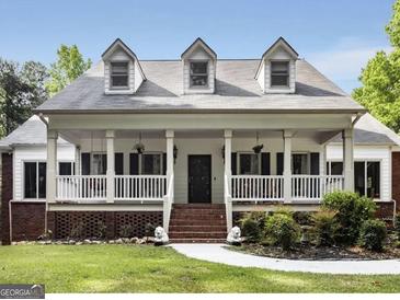 Two-story house with wrap-around porch and landscaped yard at 135 Kayla Dr, Fayetteville, GA 30215