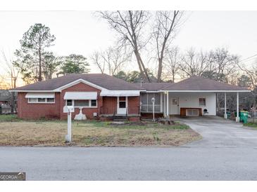 Brick ranch house with carport and mature trees at 4487 Berkshire Rd, Forest Park, GA 30297