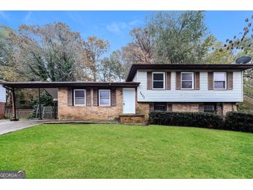 Brick ranch house with carport and well-maintained lawn at 2635 Luke Dr, Ellenwood, GA 30294