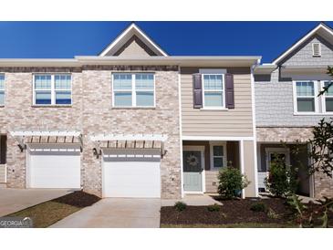 Brick front exterior of charming townhome with two-car garage at 177 Swindon Dr, Mcdonough, GA 30253