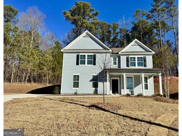 Charming two-story home with light blue siding, black shutters, and a well-manicured front yard at 2791 Riverchess Ct # 147, Atlanta, GA 30331