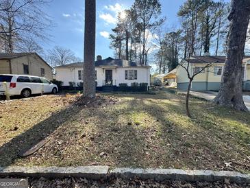 Charming single story home with a spacious front yard at 1344 Lynford Sw Dr, Atlanta, GA 30310