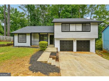 Charming one-story house with a two-car garage and well-maintained landscaping at 943 Lake Drive Ter, Stone Mountain, GA 30088